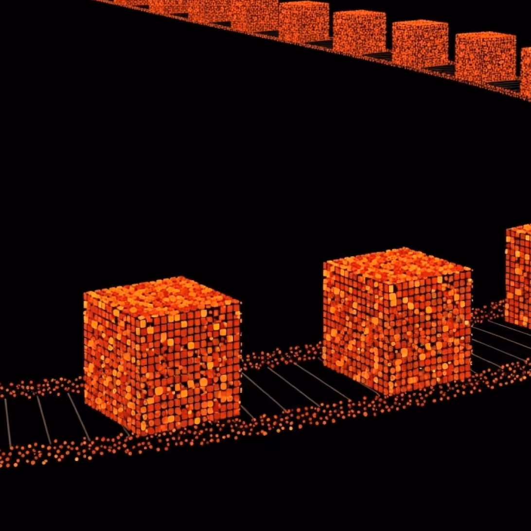Rows of glowing orange cubes made of small dots arranged on black rectangular tracks against a black background.